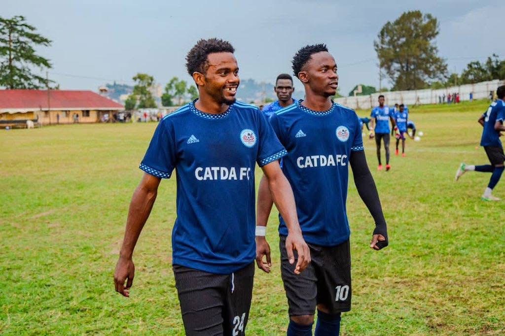 CATDA players in blue shirts together on the pitch