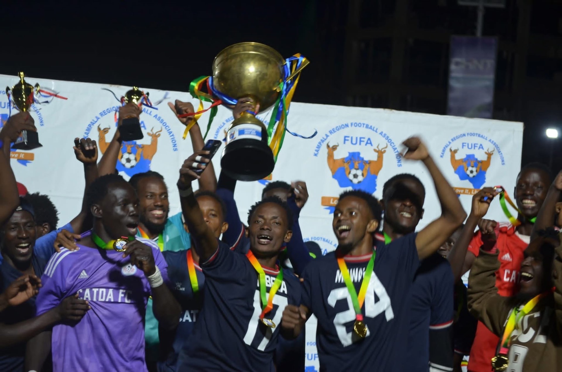 CATDA players celebrating together with their trophy